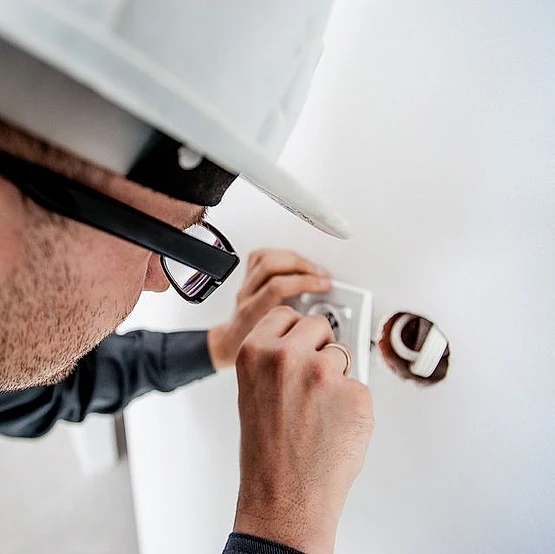 electricista profesional con casco urga en punto de luz sin miedo